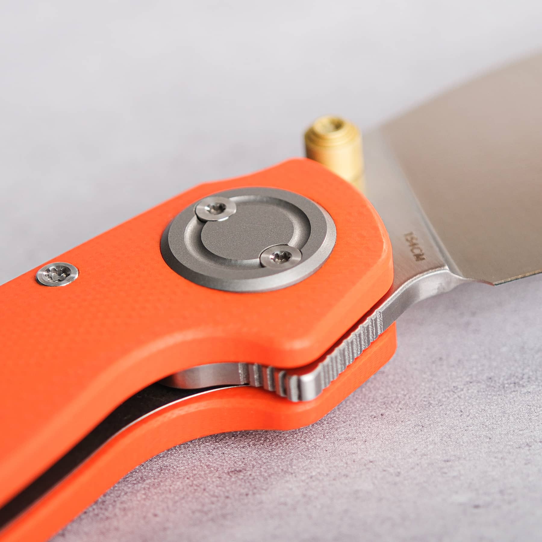 Vosteed Shilin Cutter® close-up, orange G10 handle, Vanchor Lock, 154CM blade