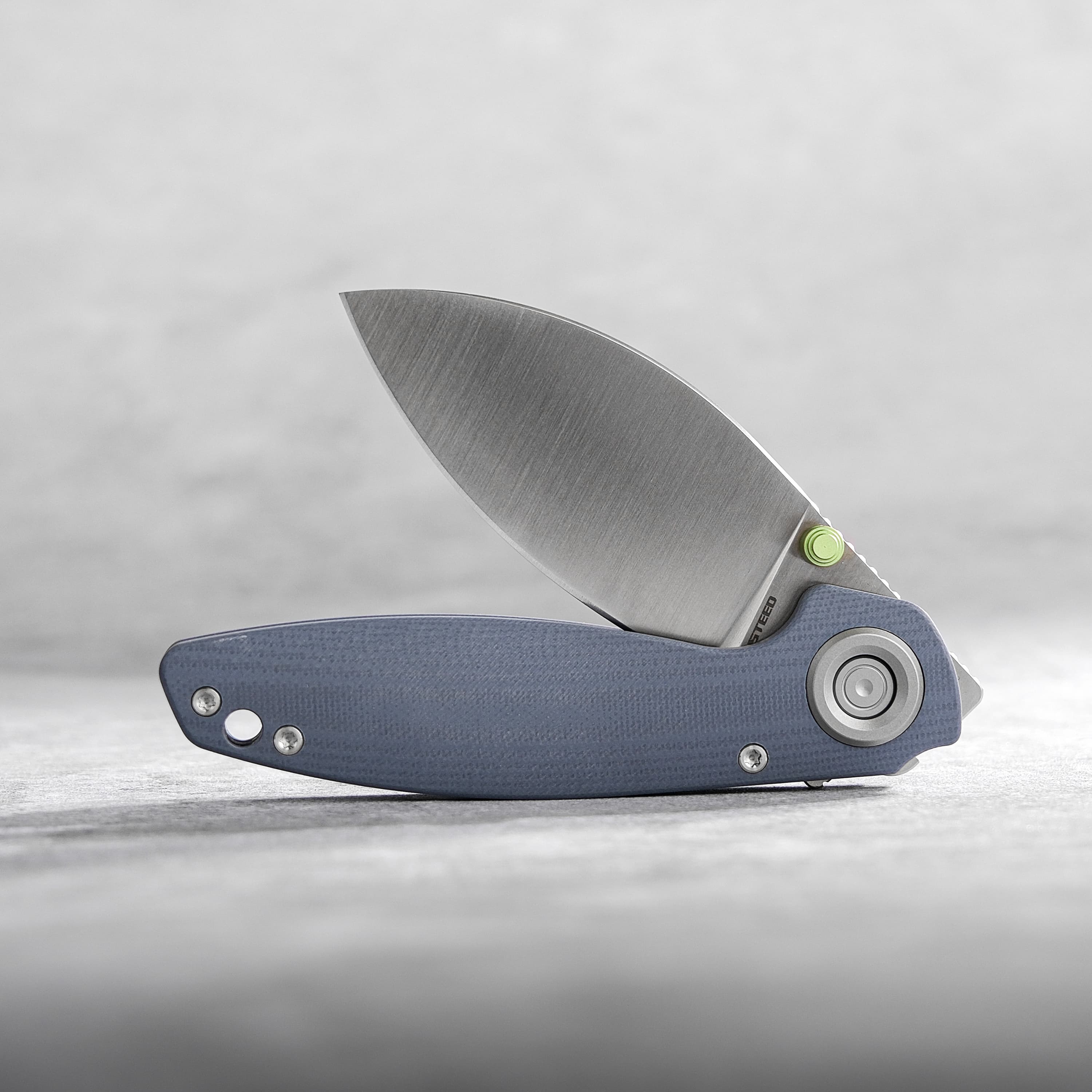 Vosteed Shilin Cutter® knife with blue G10 handle, blade open.