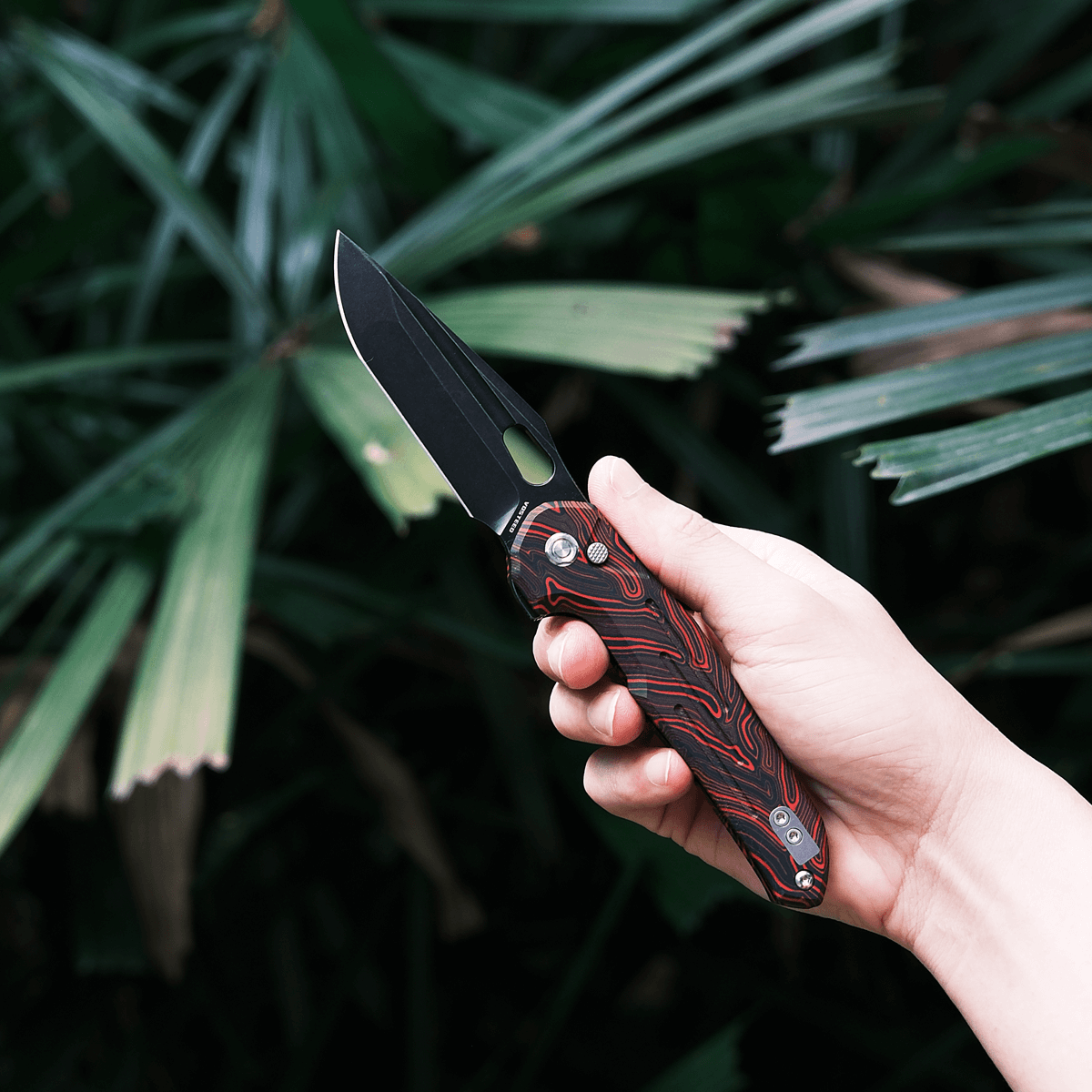 Vosteed Thunderbird Trek Lock Knife held in hand, red G10 handle
