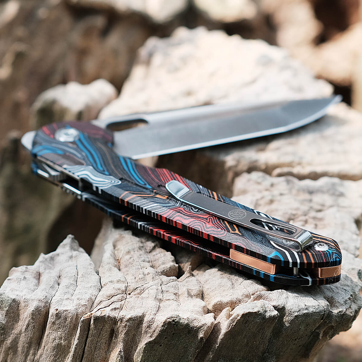Vosteed Thunderbird knife with Magpie G10 handle, blade open on wood
