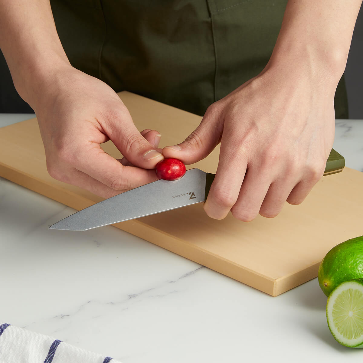 Vosteed Hackney knife cutting small fruit on cutting board
