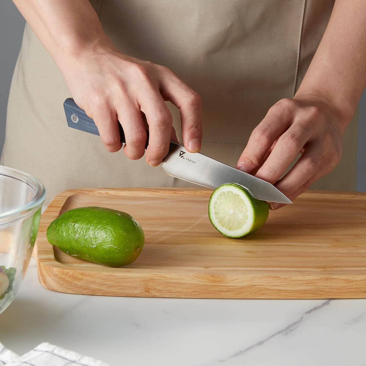 Vosteed Hackney Utility Knife slicing lime on cutting board