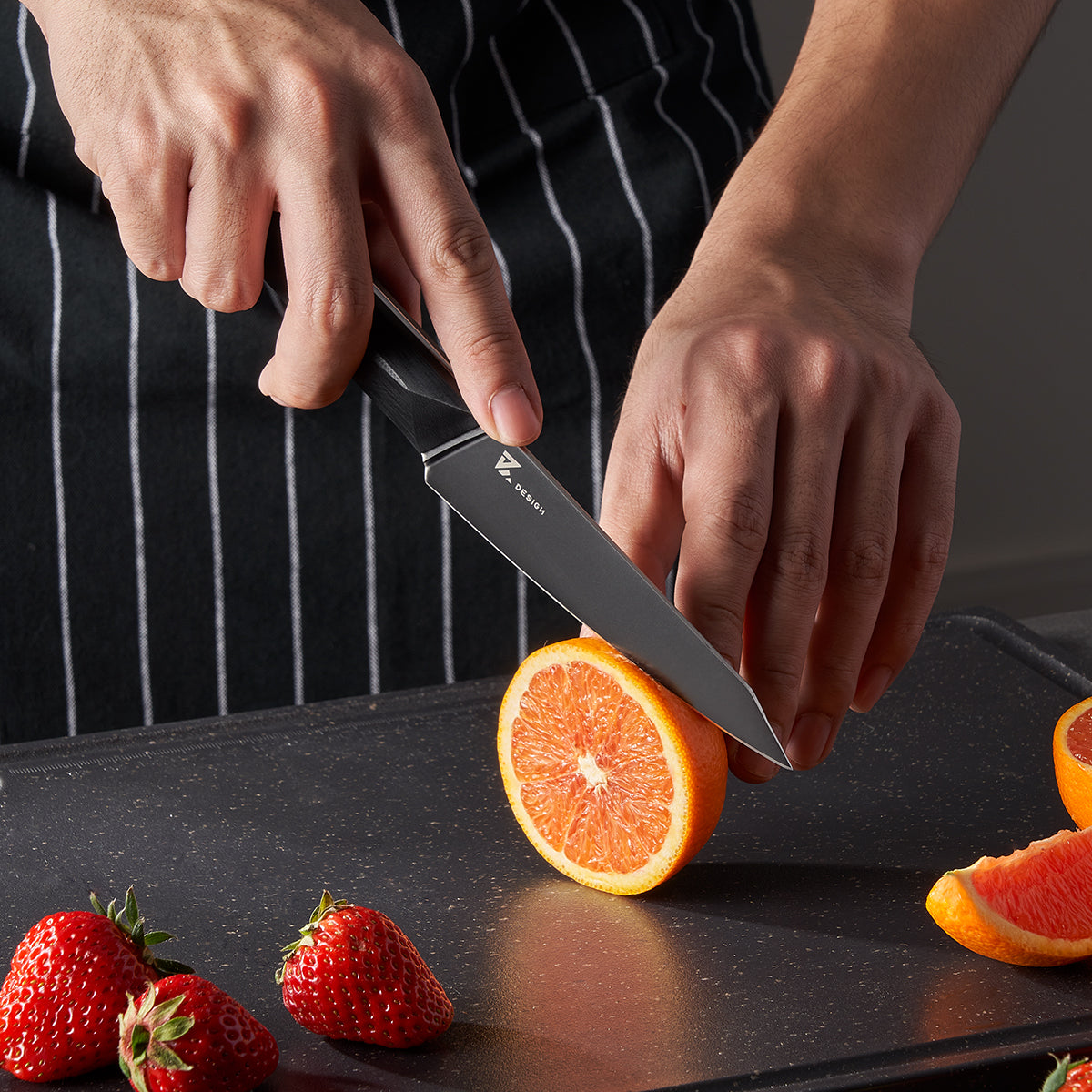 Vosteed Hackney knife slicing orange on cutting board