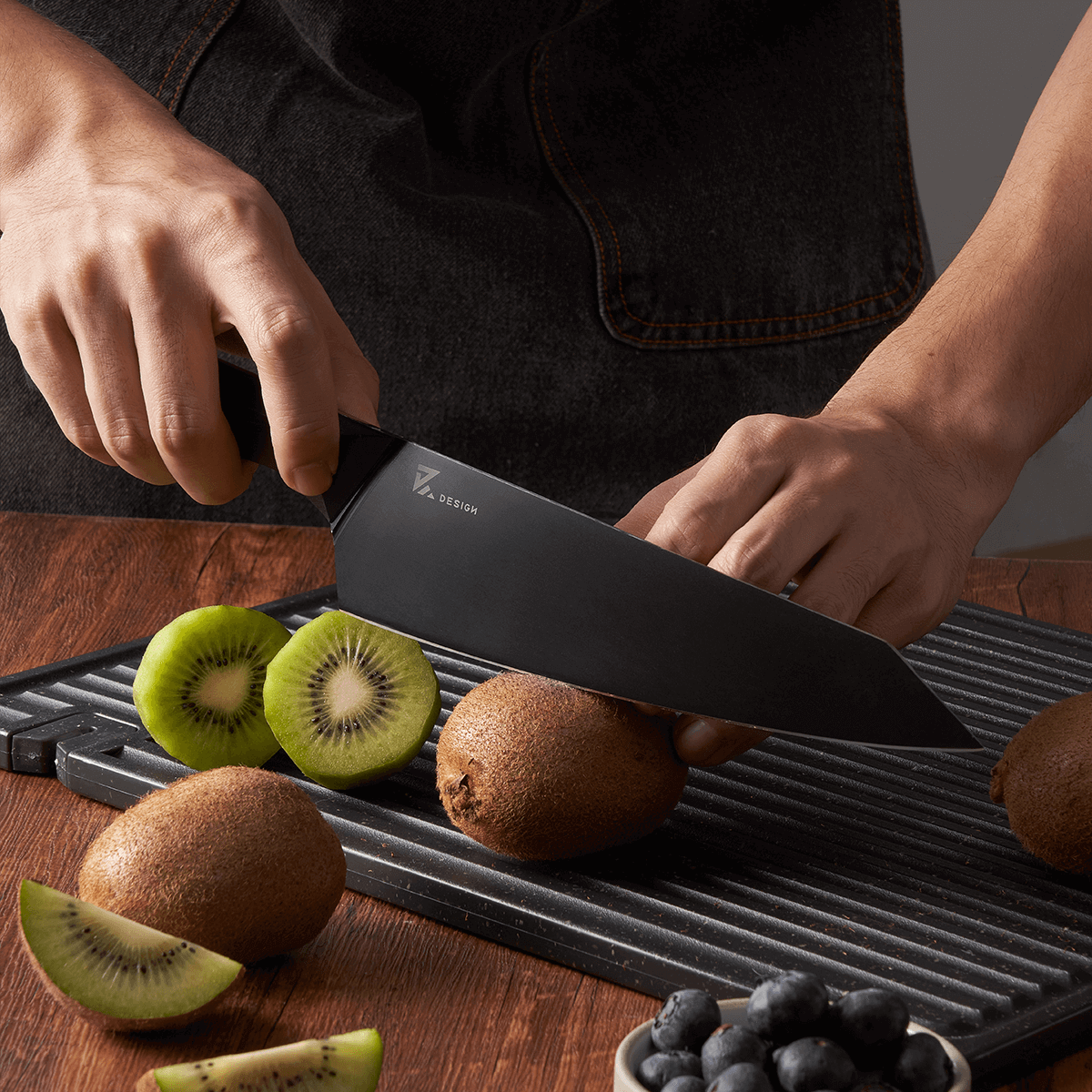 Vosteed Hackney chef knife slicing kiwi fruit