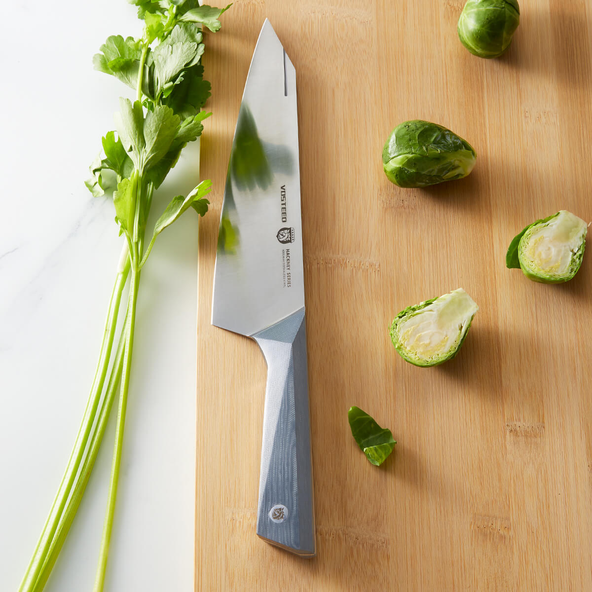 Vosteed Hackney Chef Knife on cutting board with vegetables