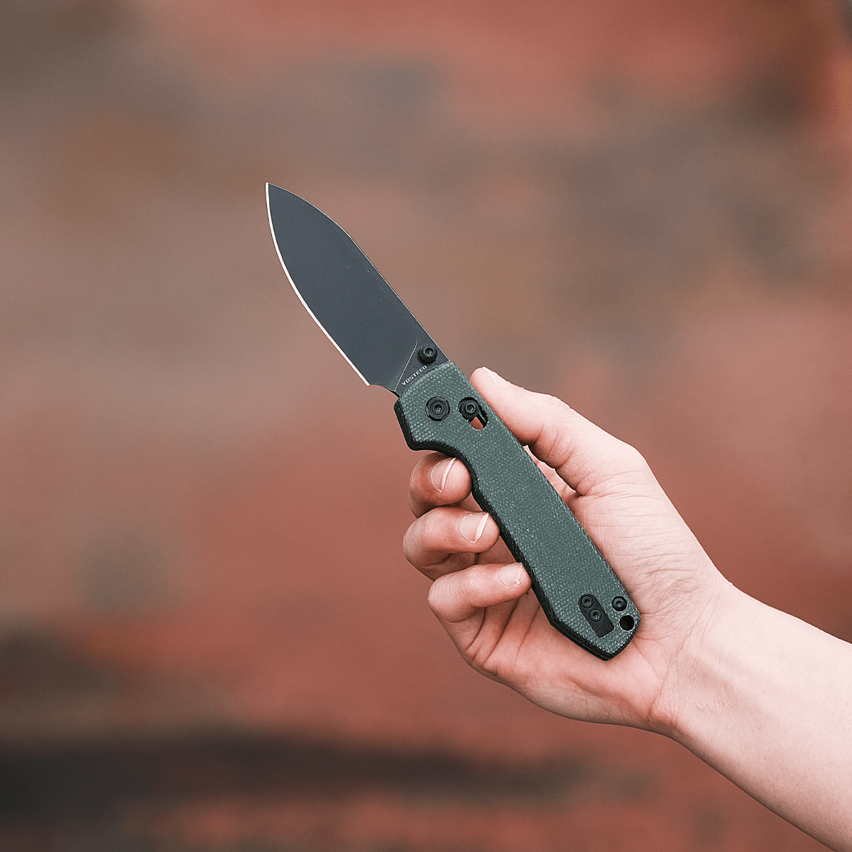 Vosteed Raccoon Crossbar Lock knife held in hand
